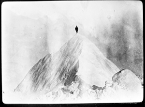 Image of Man atop high, sharp peak
